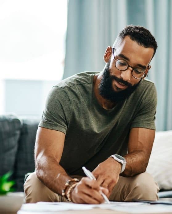 Man studying financial terms on paper for better financial literacy.